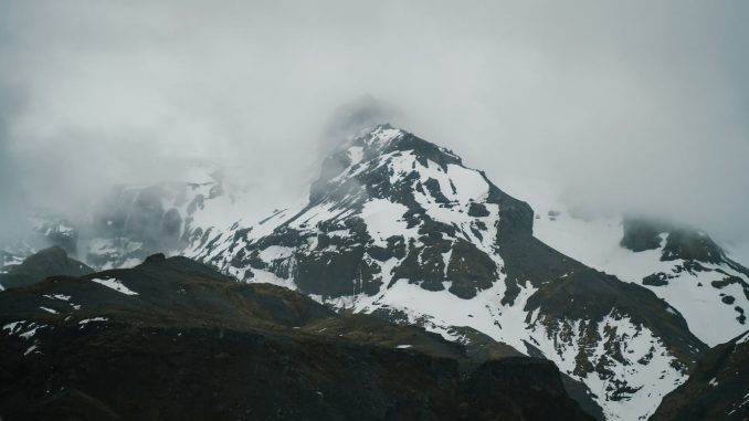 pexels-photo-5273536 severe snowy mountains under thick clouds